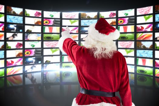 Santa Claus points at something against screen collage showing lifestyle images