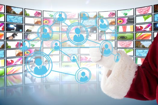 Santa Claus points at something against screen collage showing lifestyle images