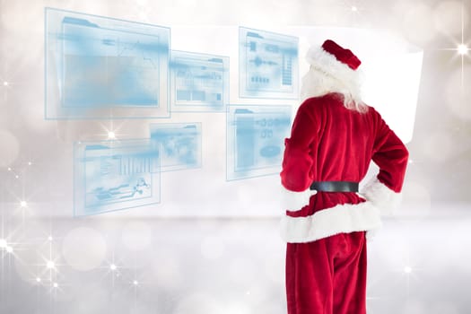 Santa looks away from the camera against twinkling lights over abstract room