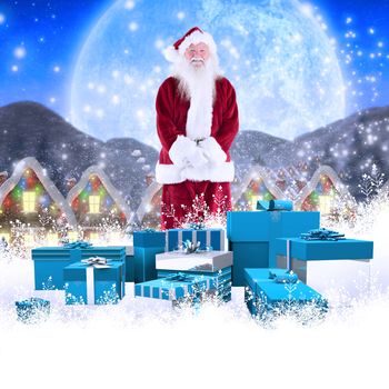 Jolly Santa smiling at camera against quaint town with bright moon