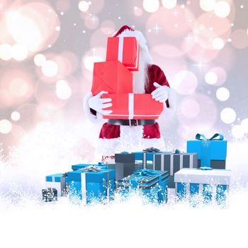 Santa covers his face with presents against white glowing dots on grey