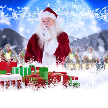 Santa asking for quiet to camera against quaint town with bright moon