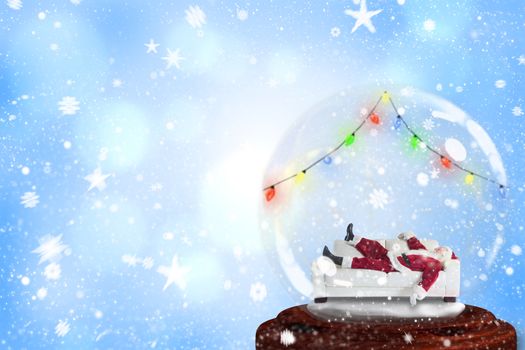 Santa sleeping in snow globe against blue abstract light spot design