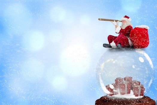 Santa sitting on snow globe against blue abstract light spot design