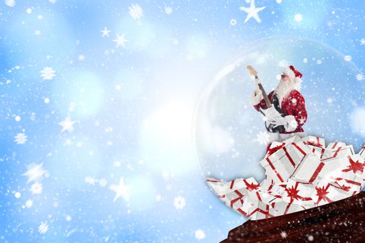 Santa rocking out in snow globe against blue abstract light spot design