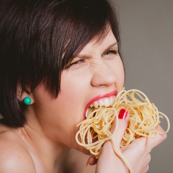 attractive woman with eating spaghetti. Concept idea 