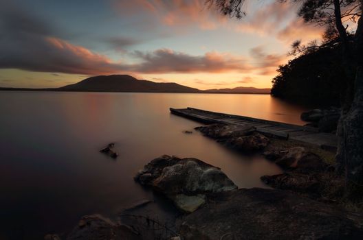 Secluded and tranquil Queens Lake Nature Reserve at sunset, with North Brother (mountain) in the distance.