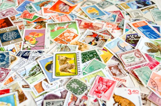 Backdrop of old worldwide postage stamps .