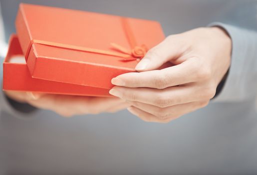 Hands of woman with gift box. Close-up photo