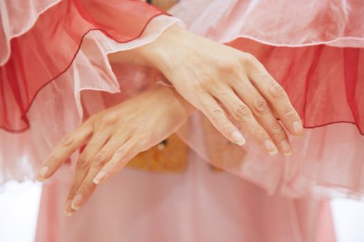 Woman in Oriental national costume dancing. Close-up view