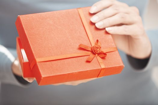Hands of woman with gift box. Close-up photo