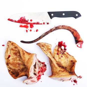 pork ears with knife and blood white background. Concept idea
