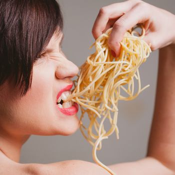 attractive woman with eating spaghetti. Concept idea 