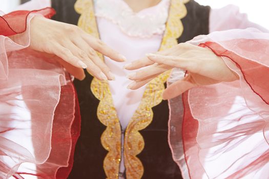 Woman in Oriental national costume dancing. Close-up view