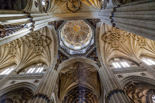 Stone Columns Dome Statues New Salamanca Cathedral Spain.  The New and Old Cathedrals in Salamanca are right next to each other.  New Cathedral was built from 1513 to 1733 and commissioned by Ferdinand V of Castile, Spain.