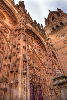 Stone Tower Door Facade New Salamanca Cathedral Spain.  The New and Old Cathedrals in Salamanca are right next to each other.  New Cathedral was built from 1513 to 1733 and commissioned by Ferdinand V of Castile, Spain. 