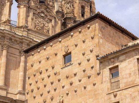 Stone House of Scallop Shells Casa de la Conchas Salamanca Castile Spain.  House of Scallop Shells is next to New Salamanca Cathedral and is now a library.  Casa de la Conchas was  bulit in 1514 by Talavera Maldonado, a knight of the order of Santiango.  The knight decorated his house with scallop shells which are associated with Saint James, the patron saint of Spain.