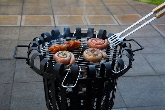 Cooking tastetful meat on a barbecue outside during winter