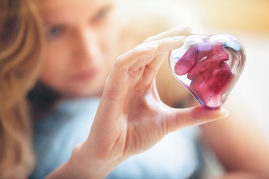Woman hands holding heart shape object