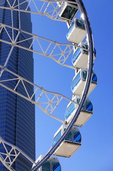 Ferris wheel on a background of tall buildings in HONG KONG