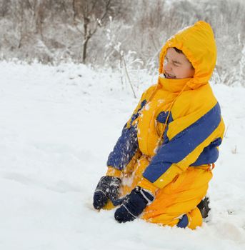 Cute little boy playing in the snow