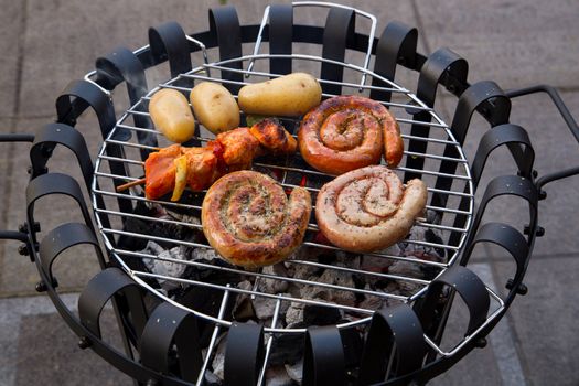 Cooking tastetful meat on a barbecue outside during winter