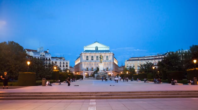 Madrid, Spain - May 10, 2012: Plaza de Oriente and Royal Theater with tourists on a spring night in Madrid, Spain