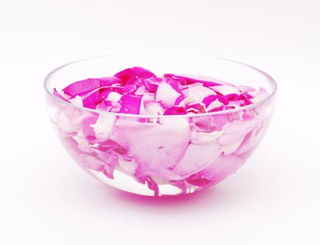 Glass cap with petals of pink roses and water