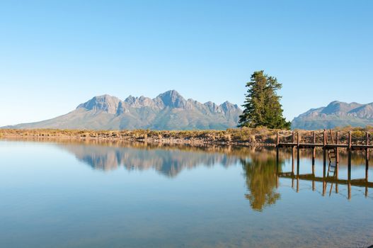 Dam with jetty near Somerset West in the Western Cape Province of South Africa with the Helderberg in the background
