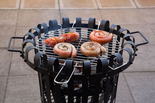 Cooking tastetful meat on a barbecue outside during winter