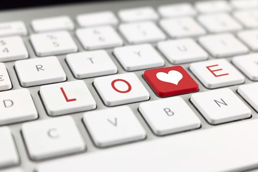keyboard button on a heart and writing Love