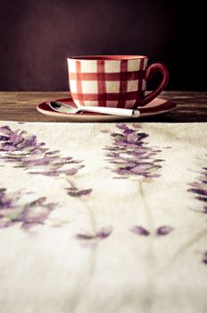 Colorful coffee cup laid on wooden vintage table