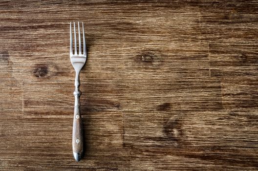 Dining fork on rustic vintage wooden table