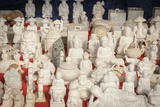 Little souvenir marble Buddha statue in local market.