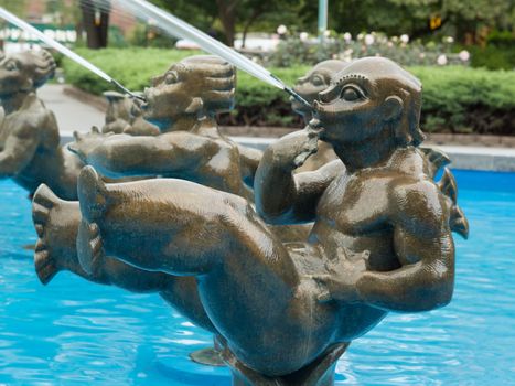 Statues spraying water at a fountain in a park located in Parkchester neighbourhood of Bronk, New York