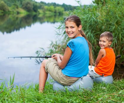 Summer vacation - Sister and brother fishing at the river