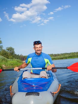 Summer vacation - Young man kayaking on the river