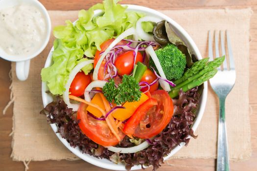 fresh vegetable salad on wood background