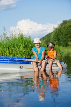 Summer vacation - Sister and brother fishing at the river