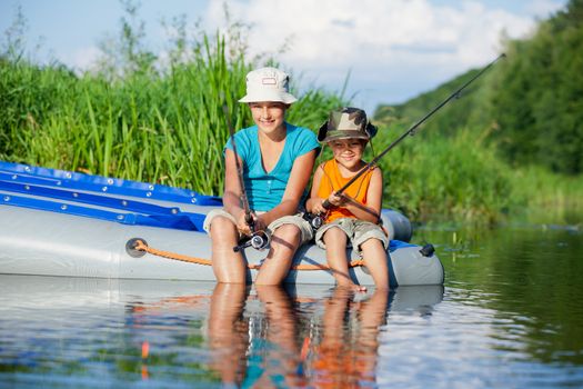 Summer vacation - Sister and brother fishing at the river