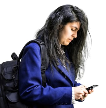 Side shot of latina teen girl with a backpck on looking down at cell phone