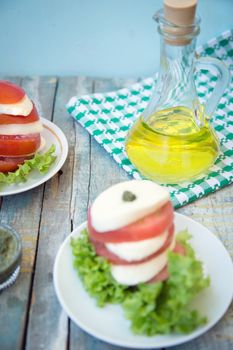 salad with mozzarella,tomatoes,dark basil on wooden retro background