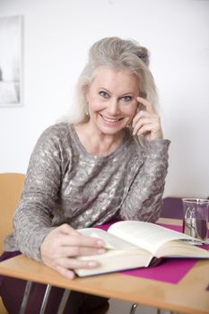 An image of a beautiful woman reading a book