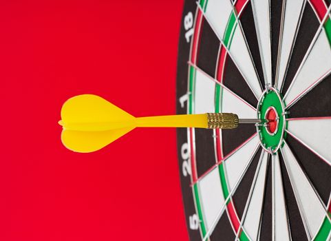 Dart sticks to bullseye on a dart board