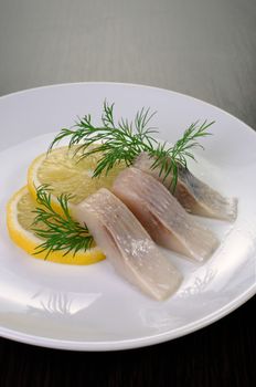 slices delicates  of herring with lemon dill