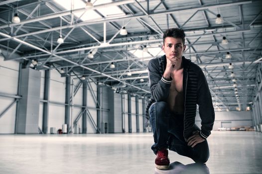Fashionable Handsome Young Man Posing Inside an Empty Building While Looking at the Camera