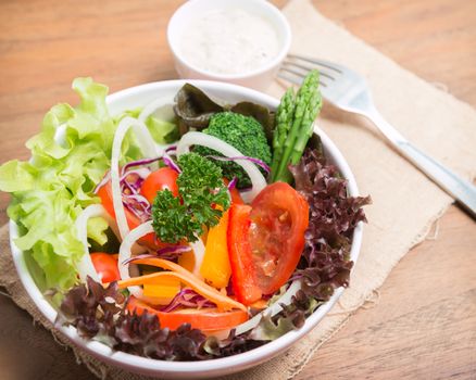 fresh vegetable salad on wood background