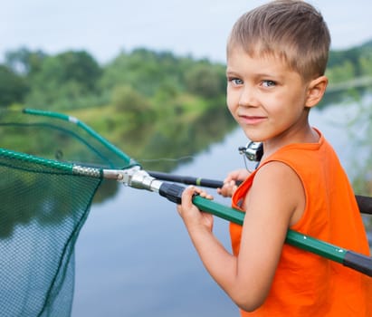 Summer vacation - Photo of little boy fishing on the river.