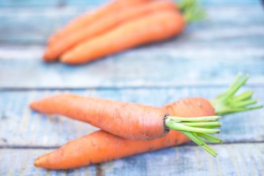 stack of fresh, to the ripe carrot on a wooden background