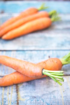 stack of fresh, to the ripe carrot on a wooden background